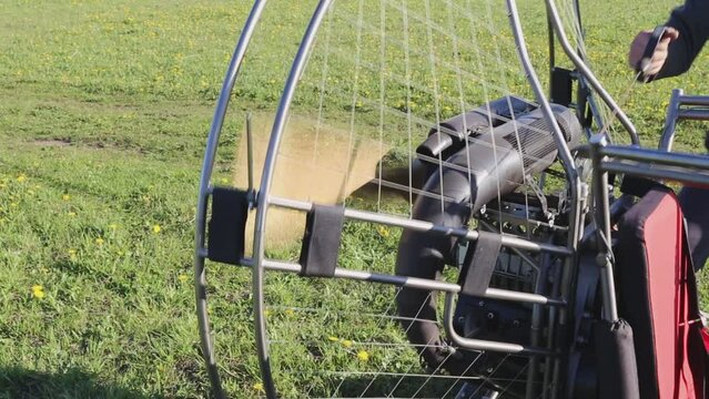 Starting paraglider motor for paragliding flights. Preparing paralet with a gasoline engine for flights. Extreme sports. Engine sound