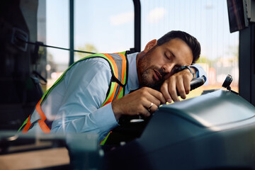 Tired bus driver fell asleep at  steering wheel.