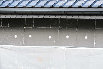 A wall of a house covered with EPS graphite polystyrene boards for thermal insulation, a building...