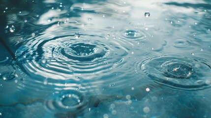 Water droplets falling into clear pool