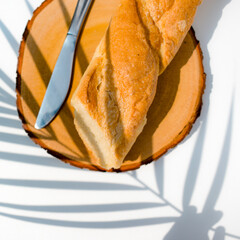 Cutting French Bread on a Wooden Cutting Board