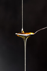 Honey poured onto a spoon.