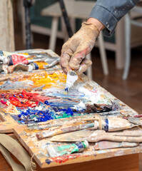 Multi-colored oil paints on the artist's table. Abstract background