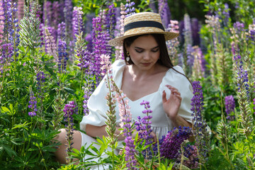 Portrait of a girl wearing a straw hat in lupine colors