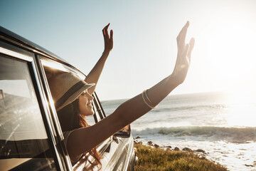 Happy woman, window and hands out with sunset in car for road trip or adventure by ocean coast in...