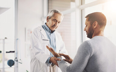 Man, doctor and patient for hand inspection of wrist checkup, arthritis and exam for diagnosis assessment. Medical, people and joint pain from accident, nerve problem and healing arm for wellness