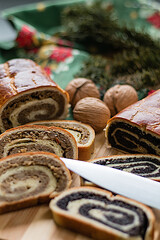 A walnut or poppy seed roll traditionally eaten in Hungary at Christmas time and three nuts and a knife.