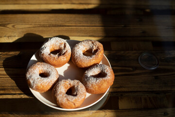 Donuts in plate on table. Delicious donuts. Treat to tea. Fried dough.
