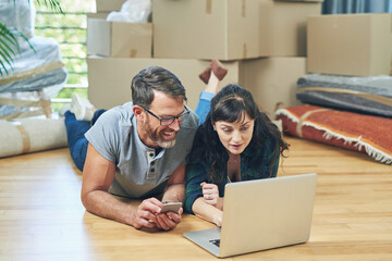 Couple, new home and happy browsing on laptop, smile and ecommerce for apartment purchase on...