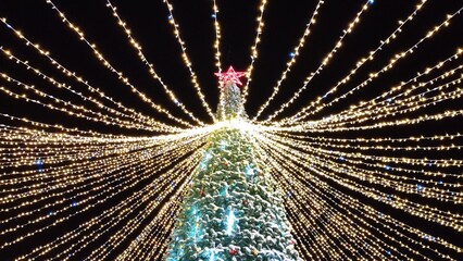 Street Christmas installation or background, Christmas tree with garlands and a star on top. Screensaver or background