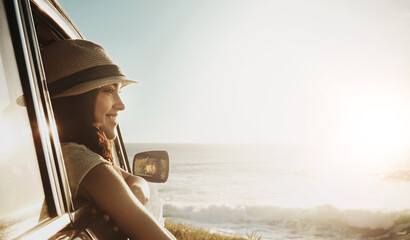 Happy girl, window and beach with sunset in car for road trip, adventure or freedom on outdoor journey. Young female person enjoying break, summer vacation or travel for view or drive by ocean coast