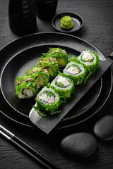 Chuka Roll. Sushi composition on black background. The Art of Japanese Cuisine. Food photography for menu and sushi bar decoration