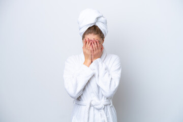 Teenager Russian girl in a bathrobe isolated on white background with tired and sick expression
