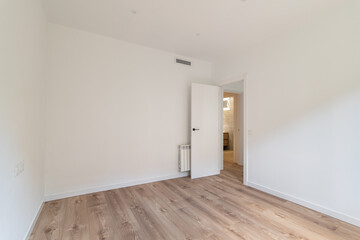 The room is modern with white walls and wooden flooring, creating a bright and clean space