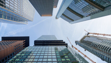 Fototapeta premium Looking up at skyscrapers in the city center