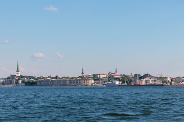 Fototapeta premium Tallinn silhouette from distance - sea side. Baltic sea Tallinn bay in front. Clear summer weather - July in Estonia.