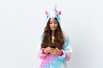 Young caucasian woman wearing a unicorn pajama isolated on white background sending a message with the mobile
