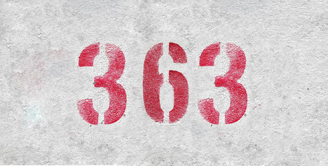 Red Number 363 on the white wall. Spray paint.