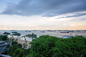 Obraz premium Siloso Beach Singapore, view from Fort Siloso skywalk, ships in Singapore strait shipping channel, tourist tourism travel destination holiday vacation