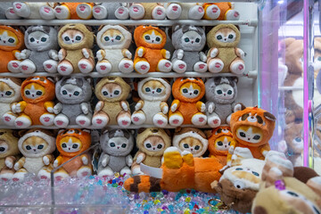 Arcade game claw machine plushie stuffed cat toy prizes, gaming social culture, kids children teenager adolescent, leisure parlour parlor