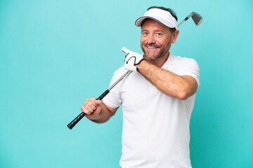 Naklejka premium Middle age caucasian golfer player man isolated on blue background pointing back