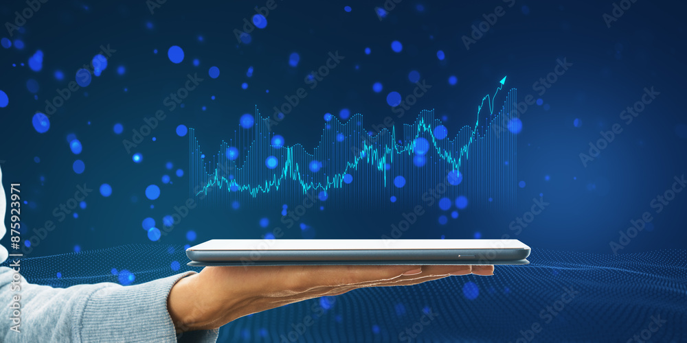Poster a hand holding a tablet with digital graphs on the screen against a blue particle background, depict