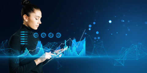 A professional woman interacting with futuristic digital graphs on a dark blue background,...