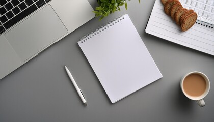 Top view of a desktop with a blank white paper sheet and a laptop, ready for ideas.