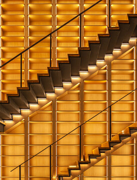 Architecture details of wooden staircase with warm white lighting design 