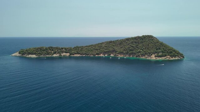 Aerial drone view of Nisida Kinira island in Greece in the summer season	
