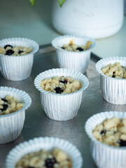 blueberry crumble muffin batter in paper cup before baking