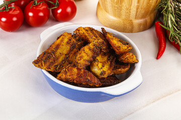 Golden baked potato Idaho with spices