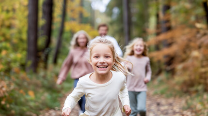 Fototapeta premium A family is running through a forest, with a young girl in the middle