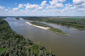 Birds eye view of Danube river with Majmunsko Island in the middle on sunny day. Surroundings of Sremski Karlovici, Serbia.