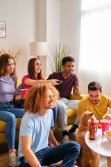 Friends watching movies together at shared student flat.