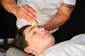 Woman getting face maderotherapy in a beauty salon. Professional skin care treatment.