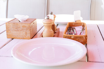 white plate and cutlery on table in cafe, serving
