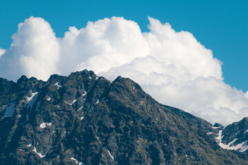 High cliffs, blue sky and white clouds. Beautiful mountain landscape. Tatra Mountains