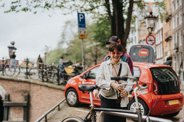 Happy lesbian couple enjoying a day out in Amsterdam, walking near a canal with parked bicycles and colorful buildings in the background.
