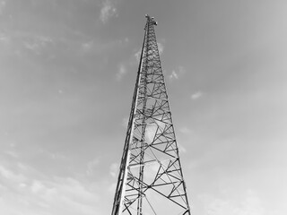 internet network tower, mobile communication in black and white color . low angle