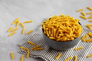 Homemade Raw Dry Gemelli Pasta in a Bowl, side view.