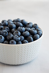 Organic Blueberries in a Bowl on a gray background, low angle view. Close-up.