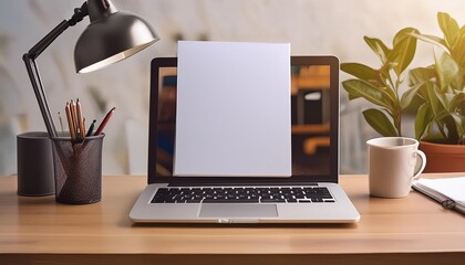 Fototapeta premium A desk with a blank white paper sheet and a laptop, showcasing workspace creativity.