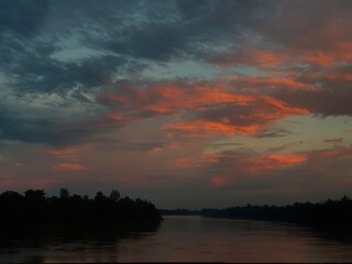 Fototapeta premium Beautiful sunset over the river with trees