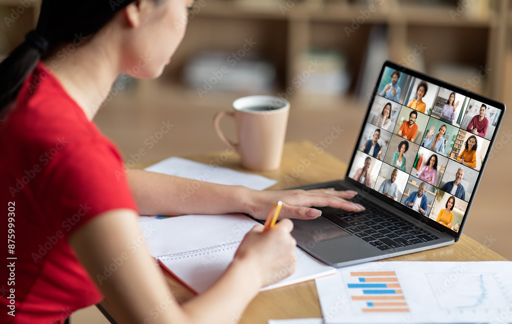 Poster A woman sits at a desk with a laptop open in front of her. She is taking notes in a notebook with a pencil while attending an online meeting. The laptop screen displays a video conference