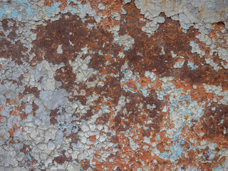 Rusty surface. Old metal with peeling paint. Rust on an uneven metal surface.