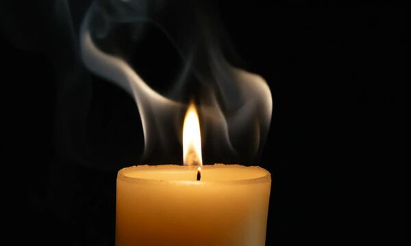 Candle blow out with smoke isolated on black background