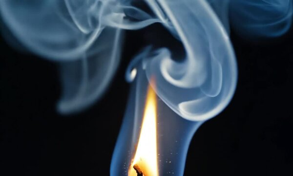 Candle blow out with smoke isolated on black background