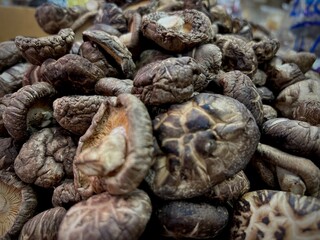 Selective focus pile of dried shiitake mushrooms in the market.
