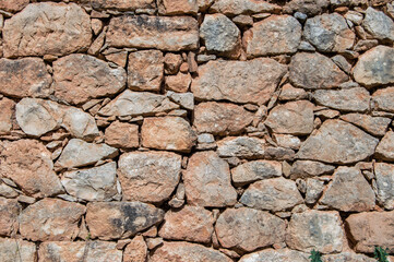 old wall with rustic reddish stones	

